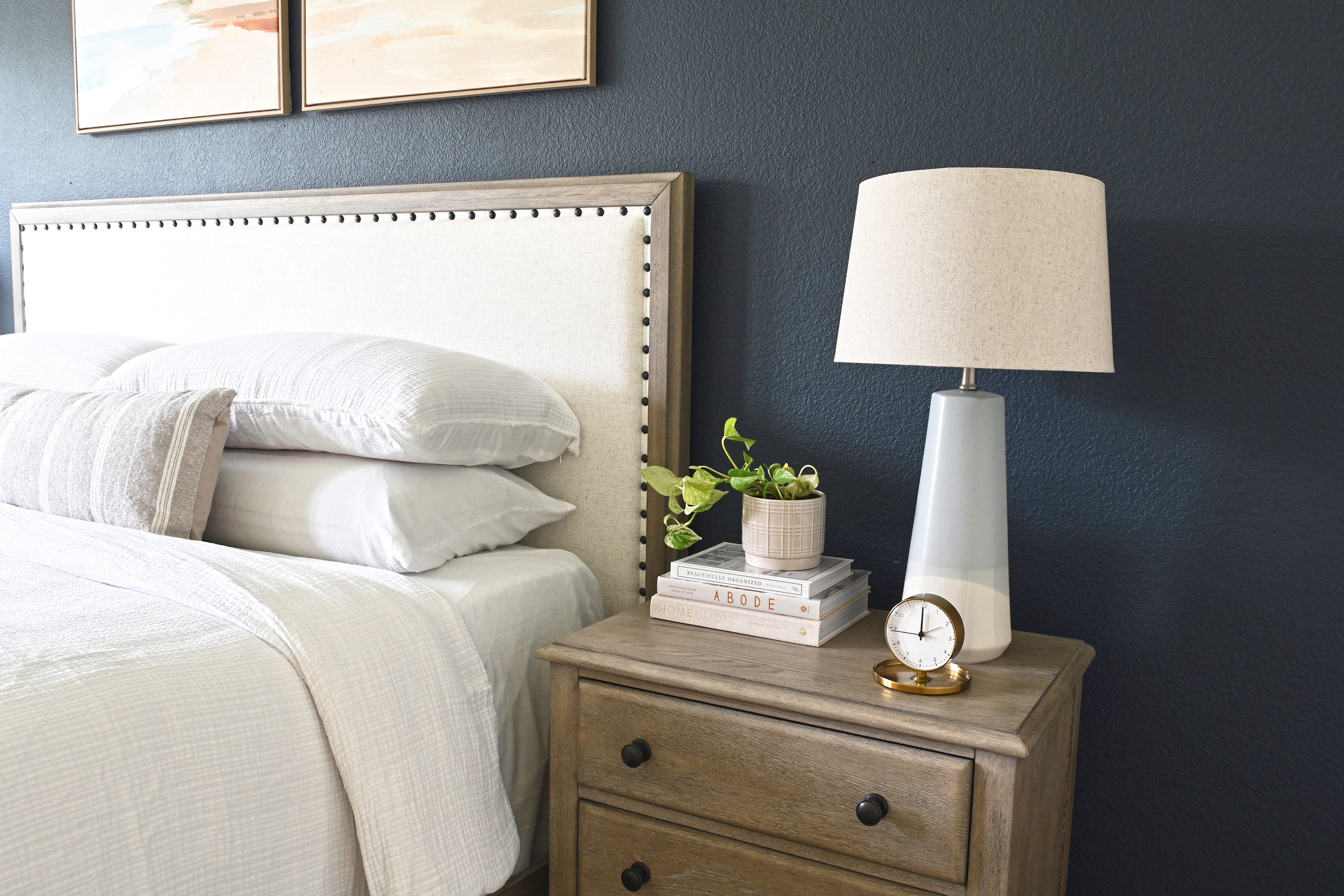 Bedroom with upholstered headboard and styled nightstand